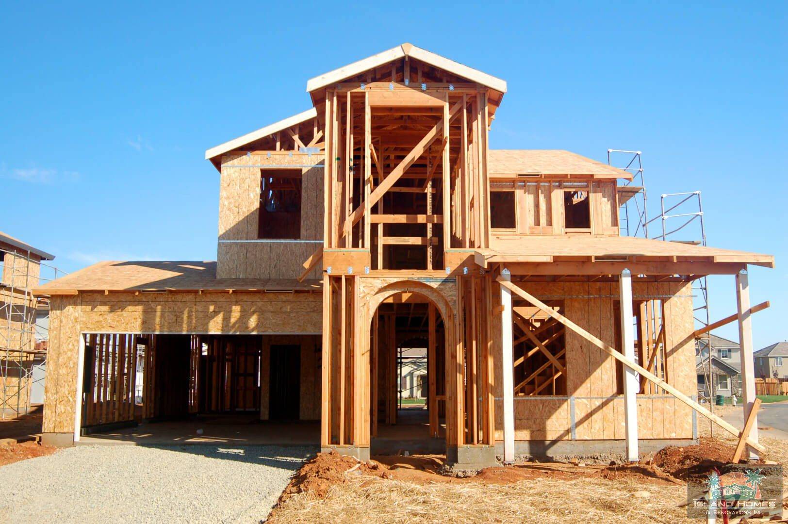 A partially built house with scaffolding and construction materials visible around the site.