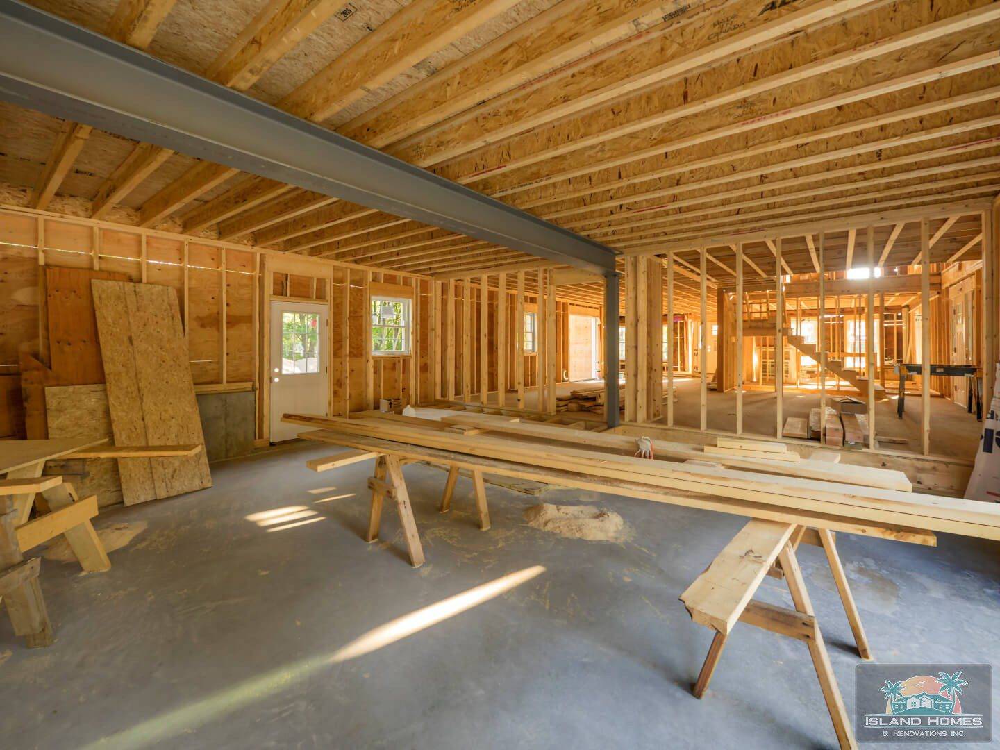 A workshop featuring wooden framing and various woodworking tools arranged on a workbench.