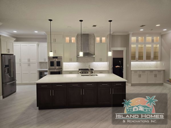 A modern kitchen featuring white cabinets and sleek stainless steel appliances.