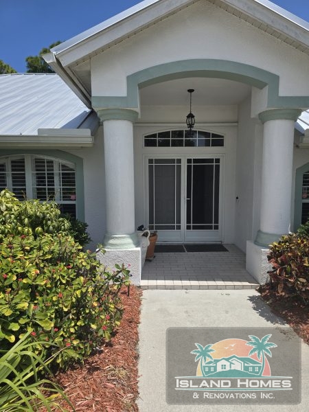 A cozy home with a welcoming front porch and a playful dog sitting nearby, enjoying the sunny day.