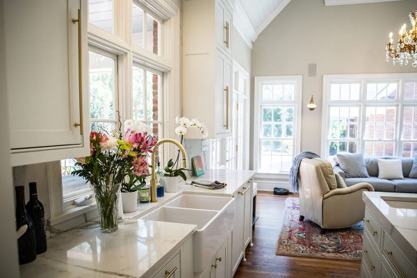 Bright and modern kitchen interior with a focus on the kitchen island and an adjacent living space