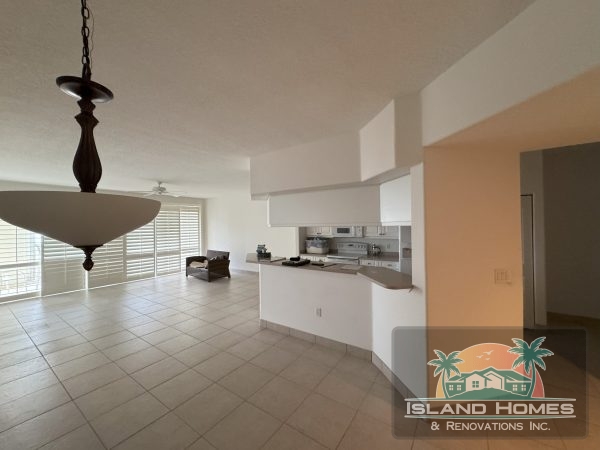A kitchen featuring tile flooring and a ceiling fan, creating a bright and airy cooking space.