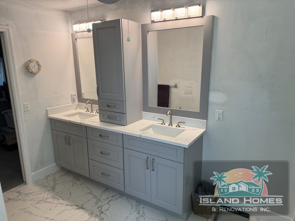 A modern bathroom featuring two sinks and a large mirror above them, with neutral-colored walls and stylish fixtures.