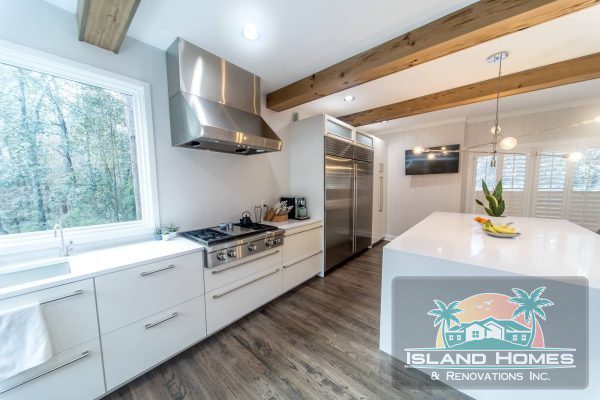 Modern kitchen interior of Island Homes, Inc. in Newport Beach, CA, featuring sleek cabinetry and contemporary appliances.