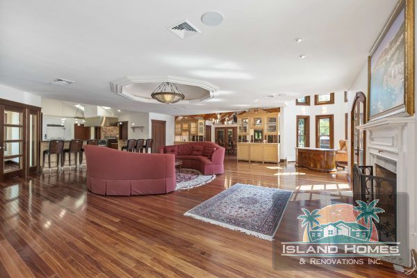 A spacious living room featuring hardwood floors and a cozy fireplace, creating a warm and inviting atmosphere.