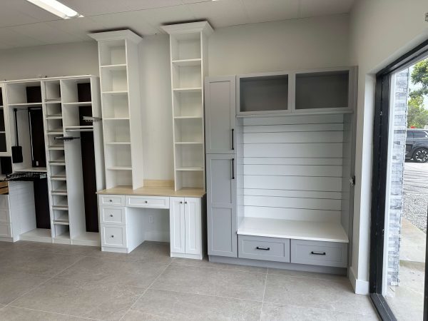 A room showcasing white cabinetry and a desk, emphasizing a bright and minimalist aesthetic.