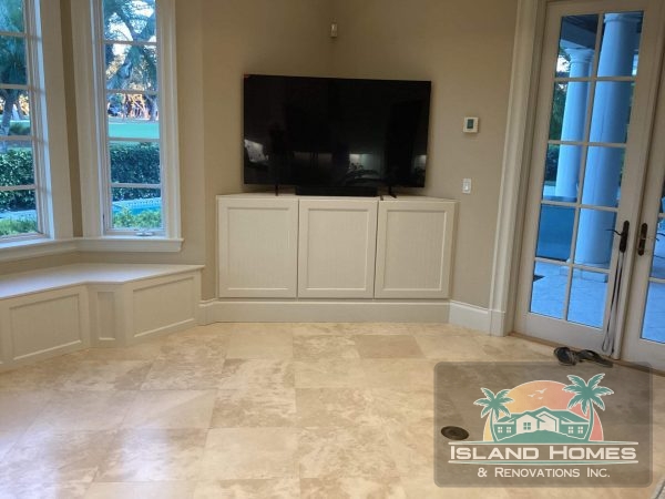 A large television mounted on a white wall, creating a modern and minimalist aesthetic in the room.